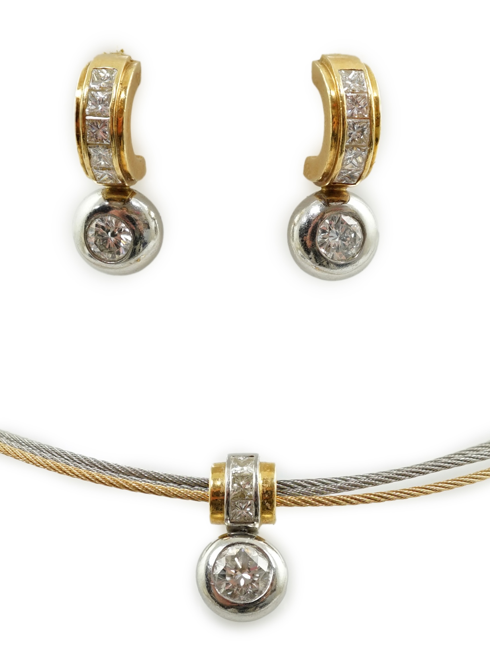 A modern platinum and 18k gold triple strand necklet, with round and princess cut diamond set pendant and a pair of matching earrings